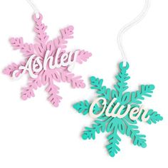 two wooden snowflakes with the word's name hanging from each ornament