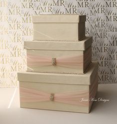 three wedding boxes stacked on top of each other