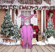 a pink bunny standing in front of a house with christmas trees and presents on the porch