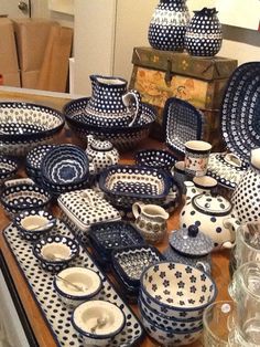 a table topped with lots of blue and white dishes