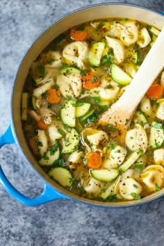 a blue pot filled with pasta and vegetables