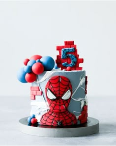 a spiderman cake with red, white and blue decorations