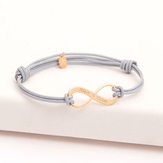 Love and friendship can last a lifetime with our Personalized Infinity Bracelet. Create a meaningful personalized gift with your hand-engraved message on the charm.18K Champagne Gold Plated, 925 Sterling Silver or 18K Rose Gold PlatedInfinity charm: 1” x 0.4”Braid made of durable, colorfast polyesterFully adjustable sliding knot fasteningThis product is also available for menEngraved by hand in our Paris workshopSent with love in a complimentary gift boxAny slight variations in lettering depth, Infinity Charm Bracelet, 4 Braids, Colored Braids, Infinity Charm, Love And Friendship, Engraved Bracelet, Sliding Knot, Champagne Gold, Metal Bracelets