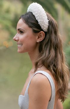 a woman wearing a white headband and smiling