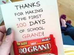 a hand holding up a candy bar with the words thanks for making the first 100 days of school grand