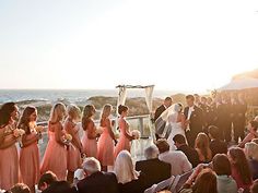 a group of people standing around each other at a wedding