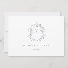 a white wedding card with the word victoria and edward in silver foil on it's front