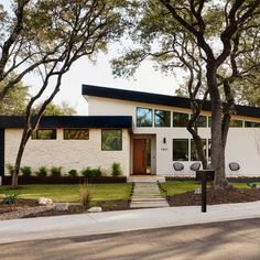 a white house with trees in front of it