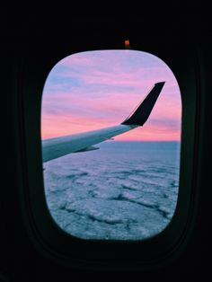 the view from an airplane window at sunset