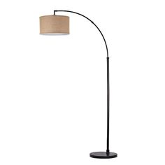 a black floor lamp with a beige shade on the base and a round light fixture