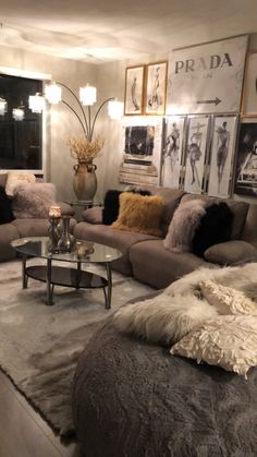 a living room filled with lots of furniture next to a wall mounted art piece on the wall