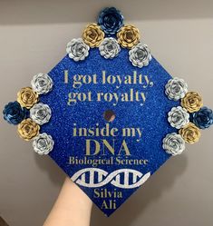 a blue graduation cap decorated with flowers and the words i got royaltyly, got royaltyly inside my dna