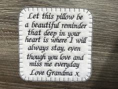 a white embroidered patch with the words love grandma written in black and white on it