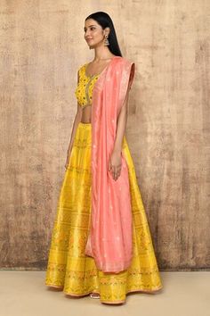 Yellow brocade silk lehenga with an attached cancan and floral pattern. Comes with a padded blouse and a pink dupatta. - Aza Fashions Choli With Sheer Dupatta For Transitional Season, Transitional Lehenga With Dupatta, Tissue Silk Traditional Drape Sets, Tissue Silk Sets For Reception, Transitional Season Sheer Dupatta Choli, Raw Silk Sharara With Tilla Embroidery, Floor-length Tissue Silk Anarkali Set, Silk Choli With Sheer Dupatta, Designer Wear Anarkali Set With Tilla