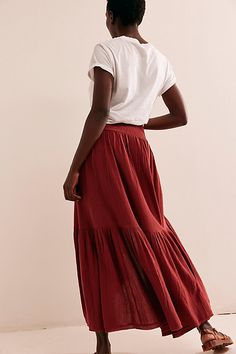 So billowy and ethereal, this stunning maxi skirt from our free-est collection will turn heads all season long. **Fit:** High-rise, billowy asymmetrical silhouette **Features:** Wide smocked waistband, drawstring feature, tiered design **Why We ❤ It:** Sleek with a simple tube top or laid back with a baby tee, this style has endless ways to wear. | Island Girl Maxi Skirt by free-est at Free People in Brown, Size: L Girls Maxi Skirt, Long Flowy Skirt, Cinnamon Brown, Brown Fits, Tiered Maxi Skirt, Island Girl, Baby Tee, Dream Wardrobe, Tube Top