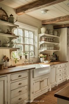 Rustic kitchen with wooden shelves, farmhouse sink, and large window with sunlight streaming in. White Counter And Backsplash, Dream Kitchen Cozy, Small Kitchen White Cabinets Ideas, White Kitchen Ideas Decor, White Farm Kitchen, Black White Kitchen Ideas, White Backsplash Kitchen, White Small Kitchen, Cream Kitchen Ideas