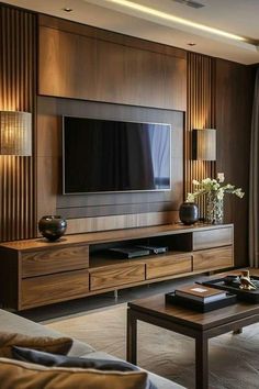 a living room filled with furniture and a flat screen tv on top of a wooden entertainment center