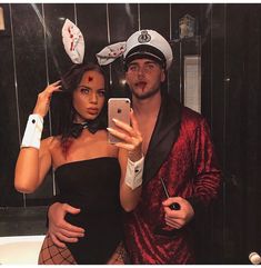 a man and woman dressed in costumes taking a selfie