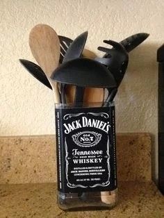 a jar filled with kitchen utensils on top of a counter