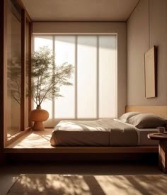 a bed sitting in a bedroom next to a window covered in blinds and a vase with a plant