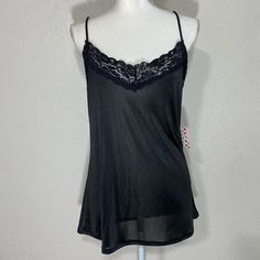 Free Kisses Black Camisole Tank Blouse Size: Large Color: Black Approximate Measurements Pit To Pit: 20in Length: 24in New With Tag Flirty Camisole With Built-in Bra For Night Out, Black Flirty Tank Top For Summer, Flirty Black Tank Top For Summer, Flirty Black Summer Tank Top, Black Tops With Adjustable Straps For Loungewear, Black Tank Top With Built-in Bra For Loungewear, Sheer Sleeveless Top For Night Out, Flirty Sleeveless Sheer Top, Black Cami Top With Built-in Bra