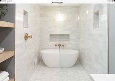 a white bath tub sitting inside of a bathroom