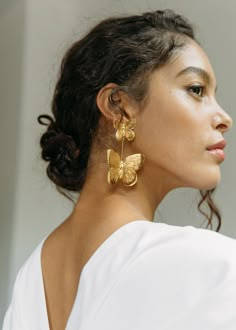 Our hearts are a-flutter over the Pamela Earrings. A twist on our best-selling Papillon Earrings, the Pamela consists of two golden butterflies, carved with intricate detail, creating the effect of a lifelike butterfly hovering mid-air. Despite their size, these earrings are incredibly lightweight and comfortable to wear, as they are crafted by hand in a process that reduces excess weight. Dimensions: 3 x 2 inches Weight: 11g each Earring Photography Styling, Accessories Photoshoot, Jewellery Photography Inspiration, Creative Jewelry Photography, Luxury Hair Accessories, Jewelry Photography Styling, Jewelry Photoshoot, Jennifer Behr, Statement Drop Earrings