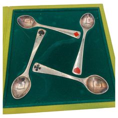 three spoons and two measuring spoons on a green tray