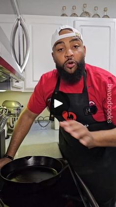 a man wearing an apron and headband is cooking in a large pan on the stove