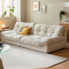 a living room with a white couch and coffee table