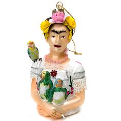 a ceramic ornament depicting a woman with two birds on her shoulder and wearing a flowered headband