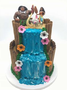 the cake is made to look like disney's waterfall with princess and prince figurines on top