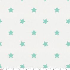 a ruler is next to a white background with green stars