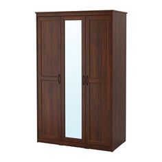 a wooden armoire with mirrored doors on the front and side panels in dark wood