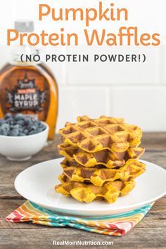 pumpkin protein waffles on a plate with blueberries and syrup in the background