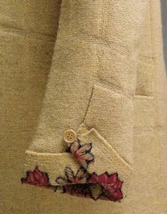 a close up of a person wearing a jacket with flowers on it