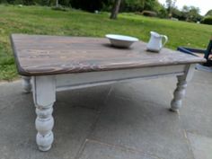 a wooden table sitting on top of a cement ground