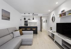 a living room filled with furniture and a flat screen tv