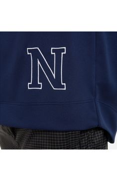 a man wearing a blue sweatshirt with the letter n on it's chest and pants