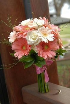 a bouquet of pink and white flowers in a vase