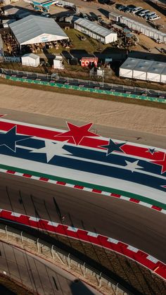 an aerial view of a race track with red, white and blue stars on it