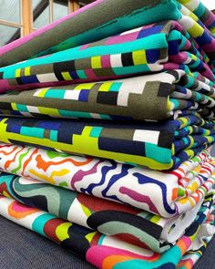 a stack of colorful fabrics sitting on top of each other