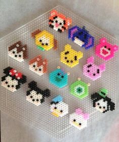 there are many small beads in the shape of animals on this plastic tray that is sitting on top of a table