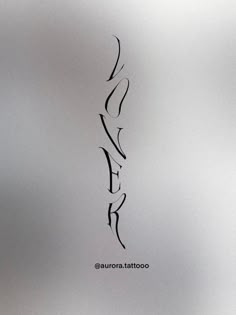 an abstract drawing of the word love in black ink on a white paper with a gray background