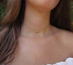 Delicate choker necklace with dainty beads in 14k gold fill or sterling silver. These beads are inspired by the Black Pepper seeds! Personalize your necklace with the number of beads you would like (choose in the drop-down menu). This gold beaded necklace is a great everyday stacking necklace or wear it on it's own for a minimalist look. #necklace #layerednecklace #RavitSchwartz Simple Gold Choker Necklace, Delicate Choker Necklace, Stacking Necklace, Delicate Choker, Gold Beaded Necklace, Starburst Necklace, Layered Choker Necklace, Stacked Necklaces, Layered Chokers