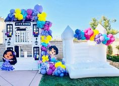 an inflatable house is decorated with balloons