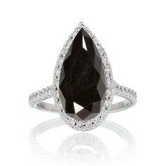 a black and white diamond ring with diamonds around it on a white background, in the shape of a teardrop