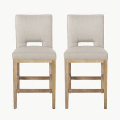 two beige upholstered stools against a white background, one with an open back and the other without