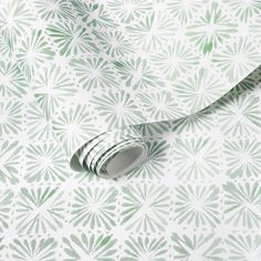 a green and white wallpaper with leaves on it