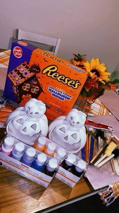 an assortment of crafting supplies sitting on a table with sunflowers in the background